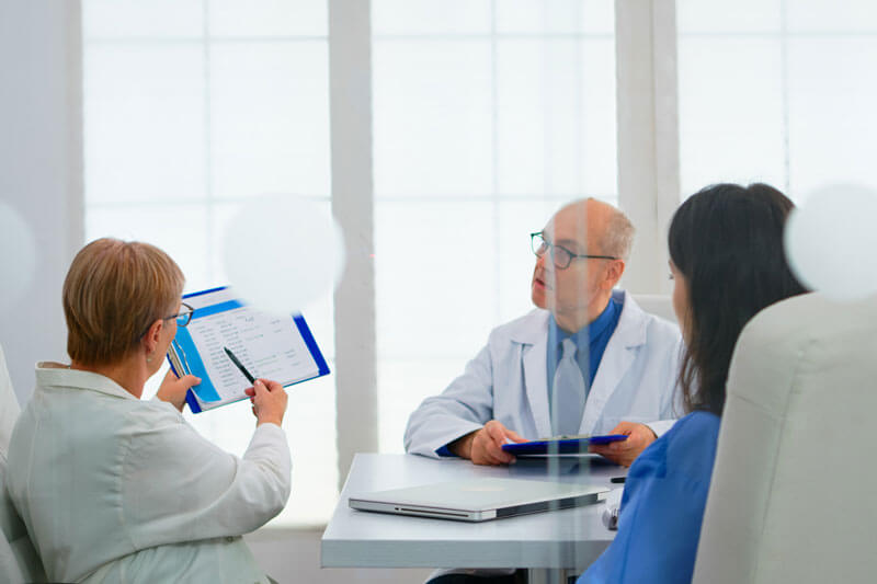 elderly doctor having medical conference in hospital